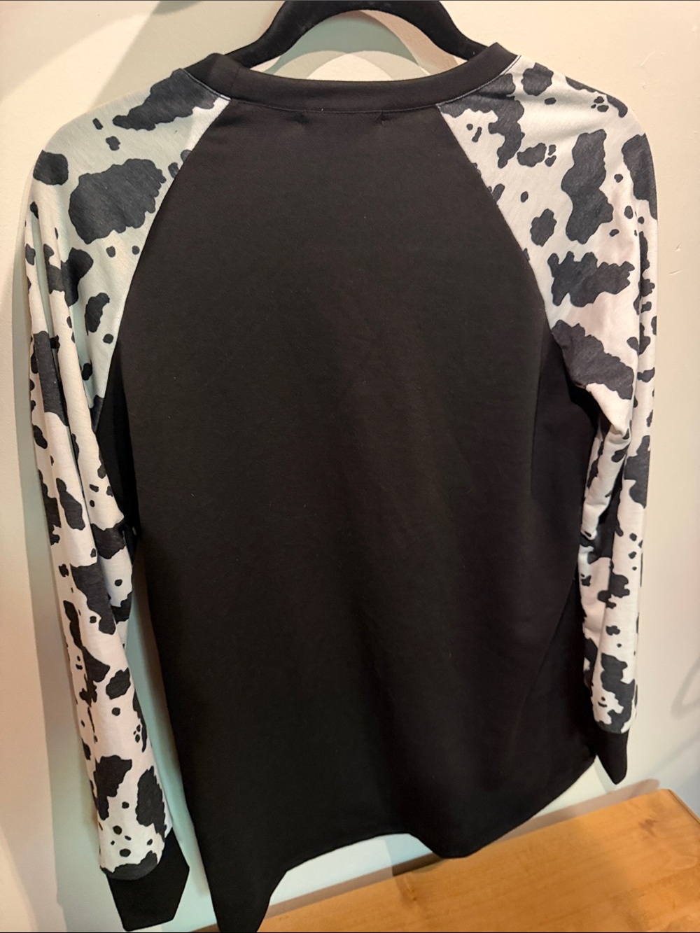 Avery Black Top with Black-and-White Cow Print Raglan Sleeves - Picture 3 of 3